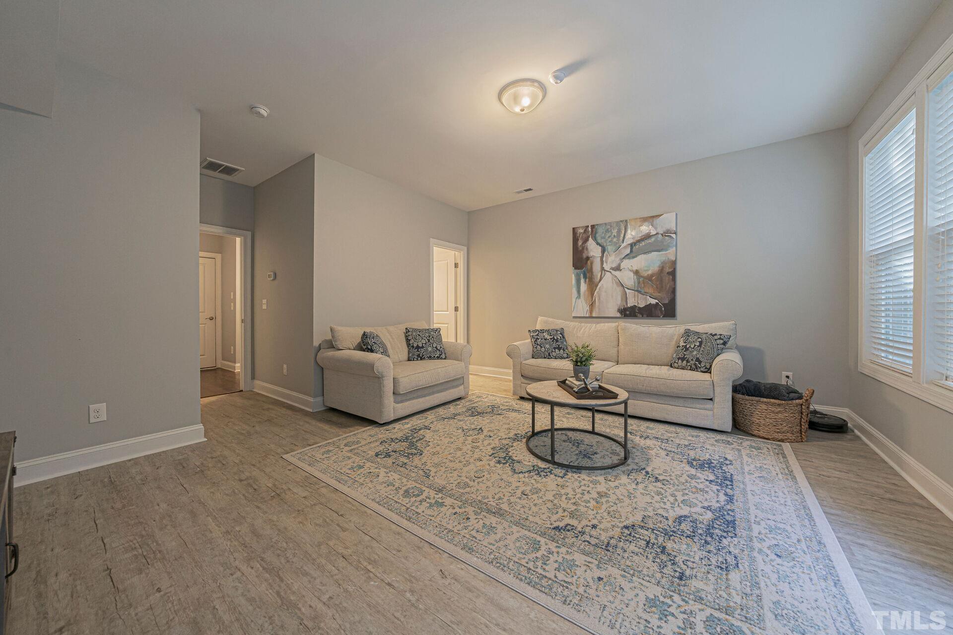 3604 Winifred Way Raleigh, NC 27609 - Photo 15 of 19 a living room with furniture and a potted plant