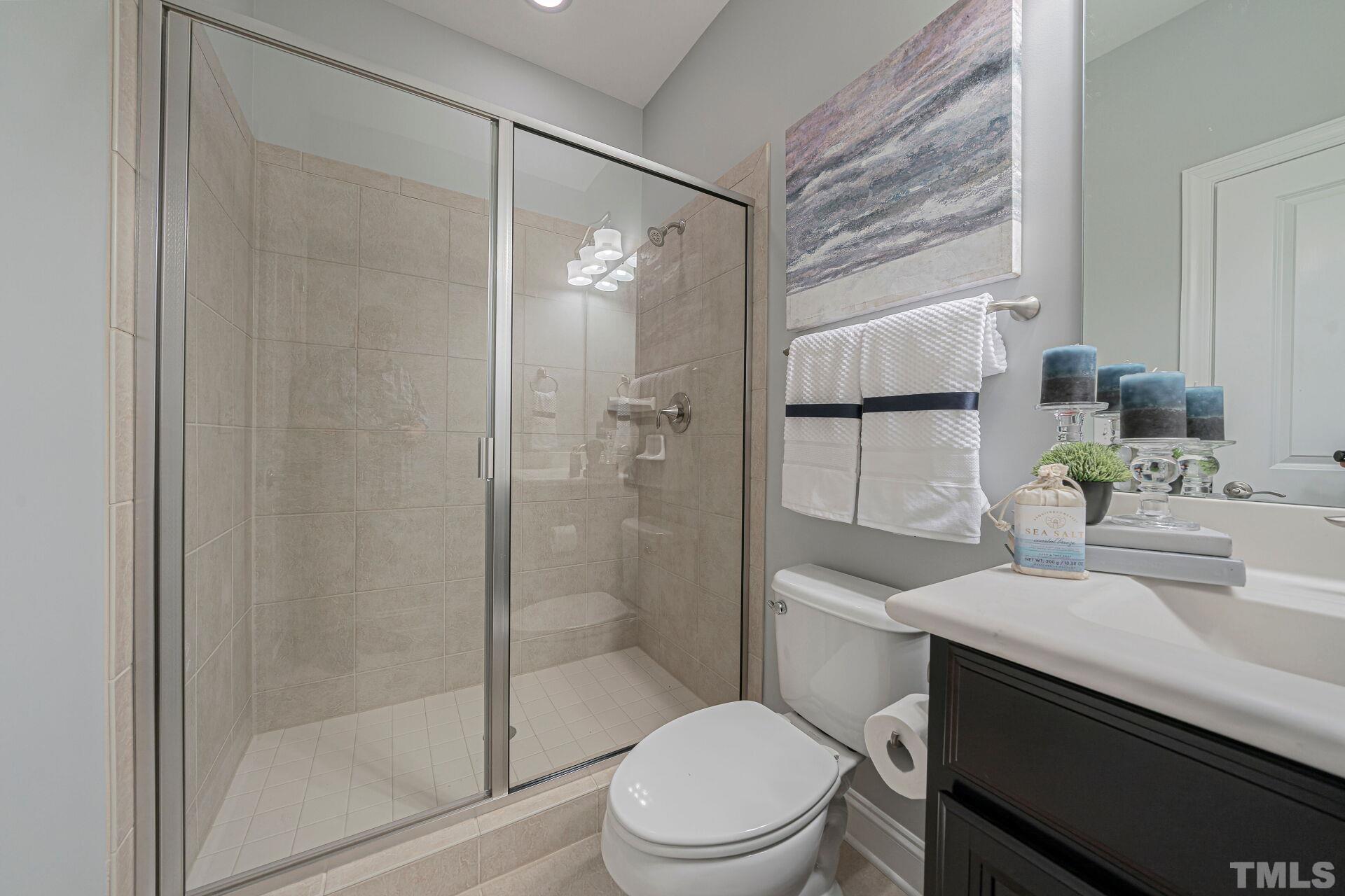 3604 Winifred Way Raleigh, NC 27609 - Photo 17 of 19 a bathroom with a sink toilet and shower