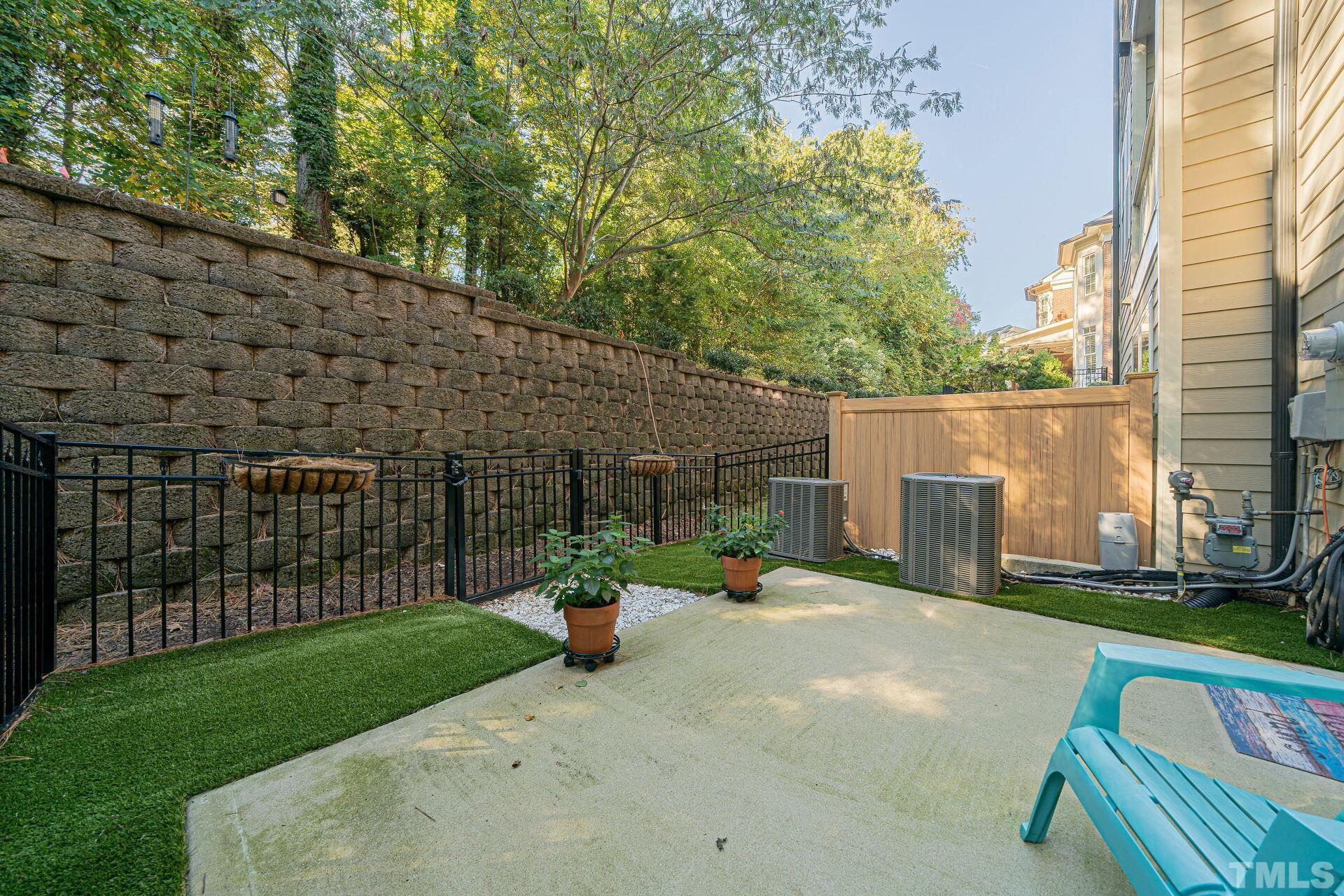 3604 Winifred Way Raleigh, NC 27609 - Photo 18 of 19 a view of a chair and table in the back yard of the house