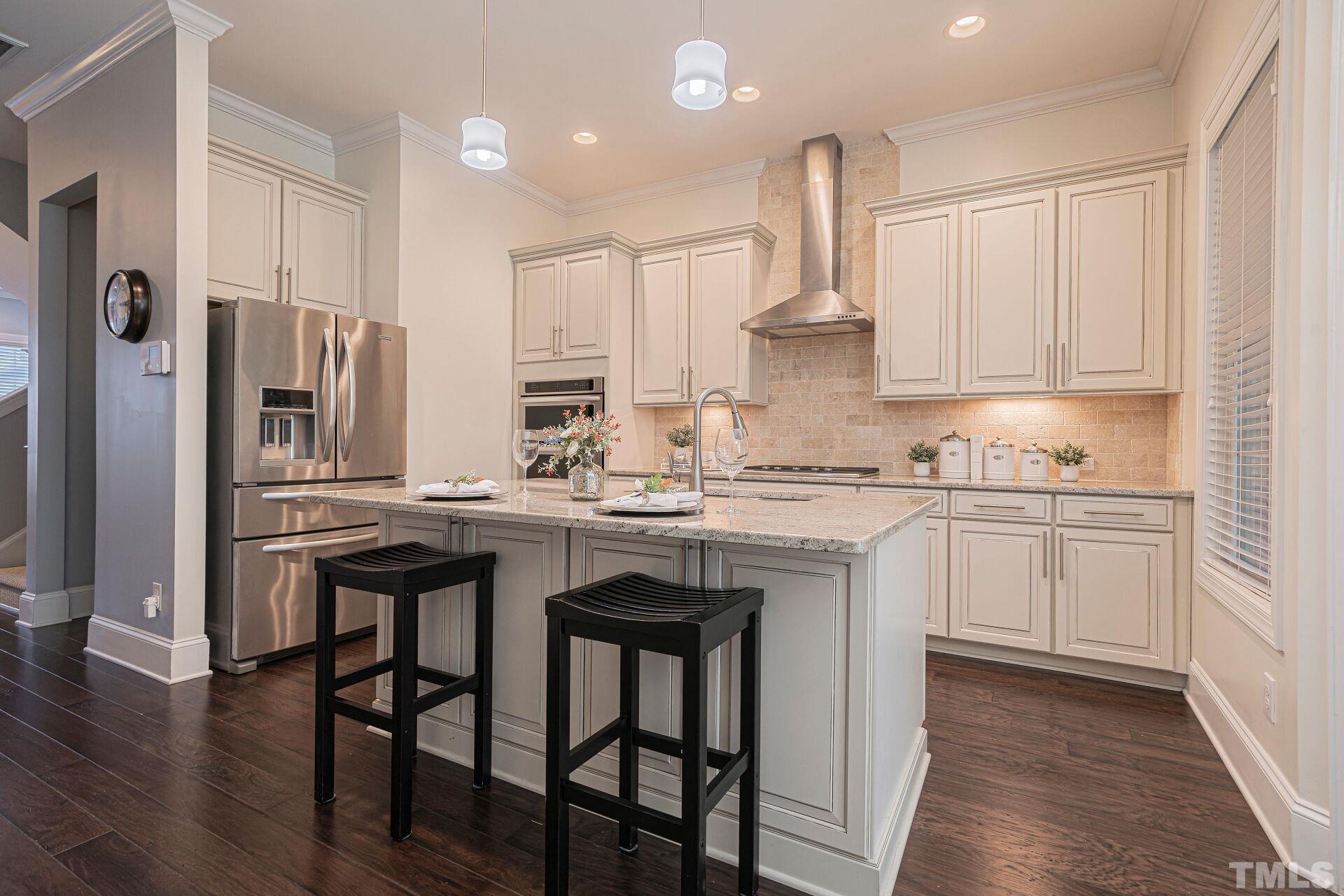 3604 Winifred Way Raleigh, NC 27609 - Photo 6 of 19 a kitchen with stainless steel appliances granite countertop a sink and white cabinets