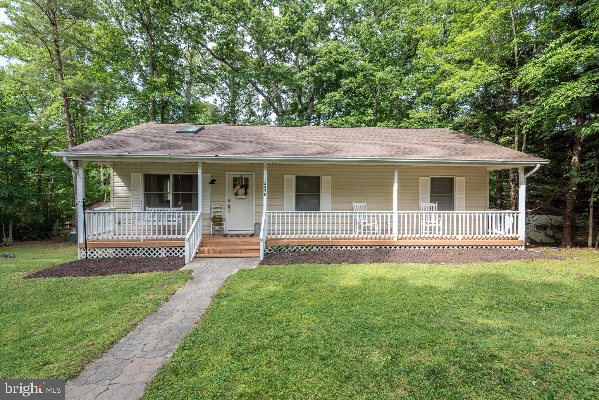 12430 Ridge Road Lusby, MD 20657 - Photo 12 of 36 a front view of a house with a yard and porch