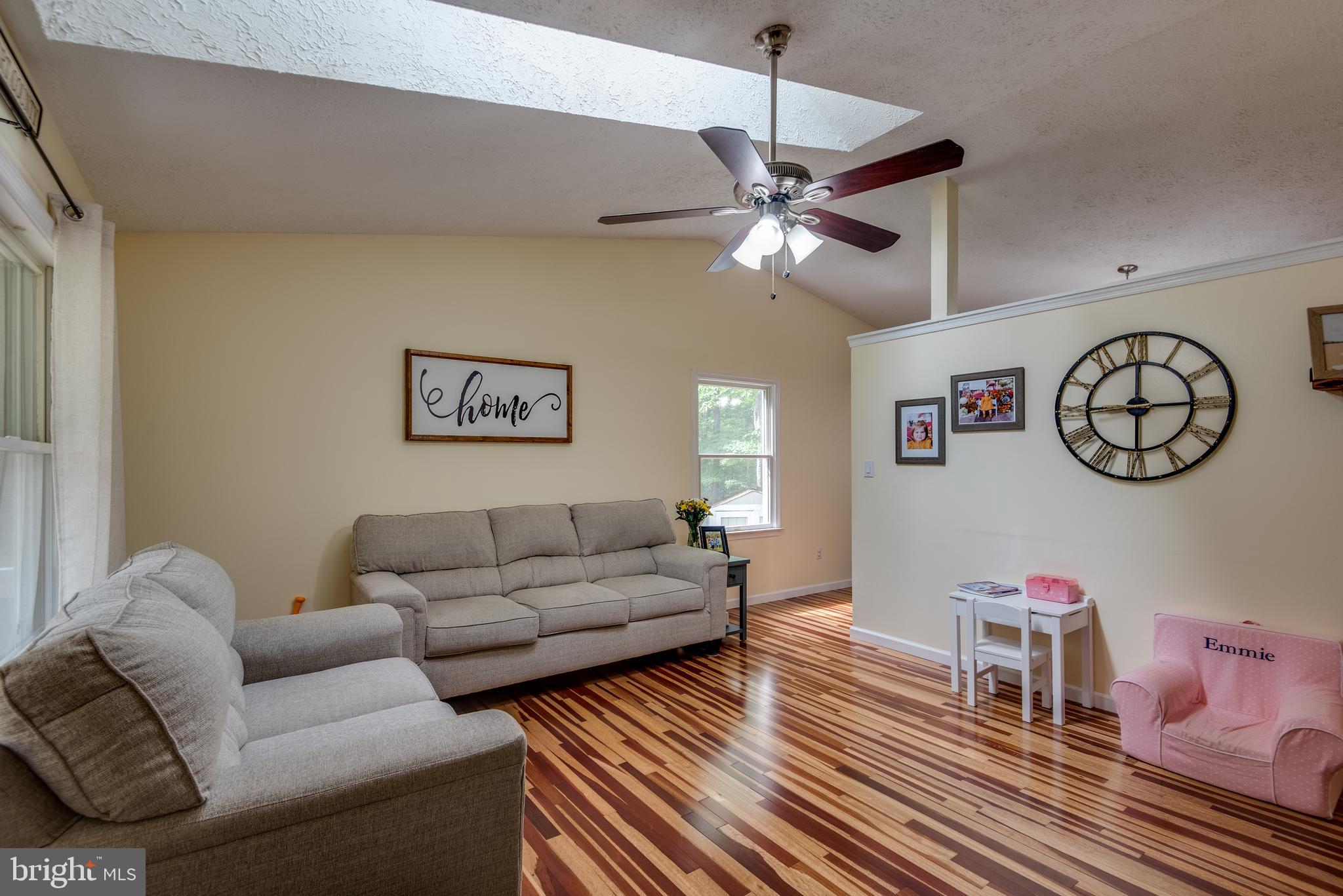 12430 Ridge Road Lusby, MD 20657 - Photo 15 of 36 a living room with furniture a clock and a ceiling fan
