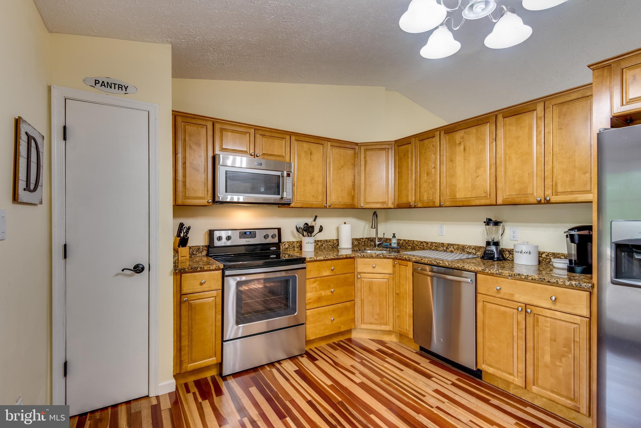 12430 Ridge Road Lusby, MD 20657 - Photo 18 of 36 a kitchen with stainless steel appliances granite countertop a stove a sink dishwasher and a refrigerator