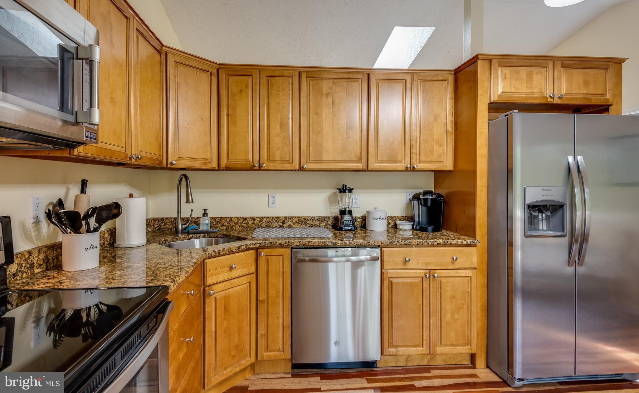 12430 Ridge Road Lusby, MD 20657 - Photo 19 of 36 a kitchen with stainless steel appliances granite countertop a refrigerator a stove and a sink