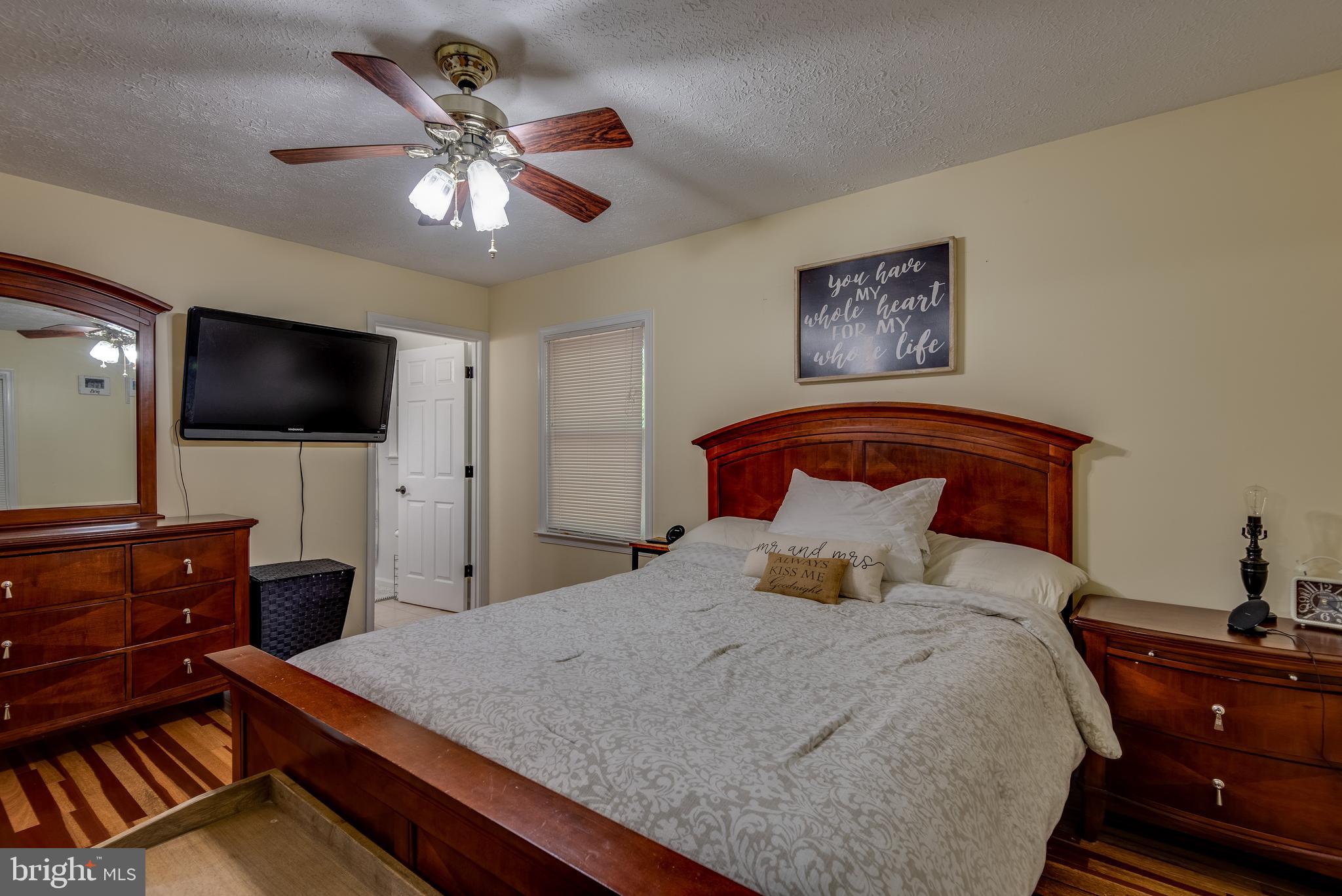 12430 Ridge Road Lusby, MD 20657 - Photo 23 of 36 a bedroom with a bed and a flat screen tv
