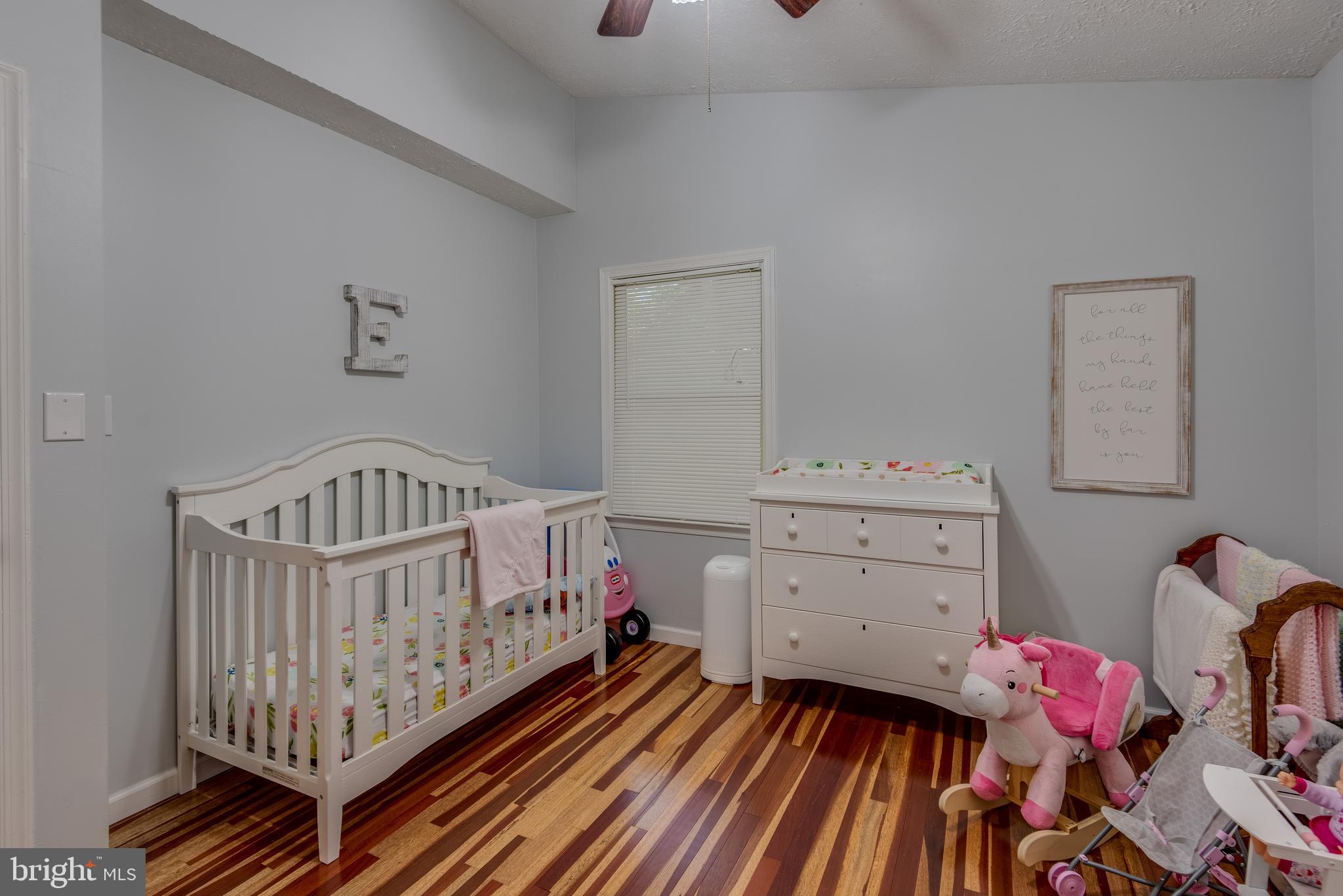12430 Ridge Road Lusby, MD 20657 - Photo 25 of 36 a bedroom with a baby crib and a dresser