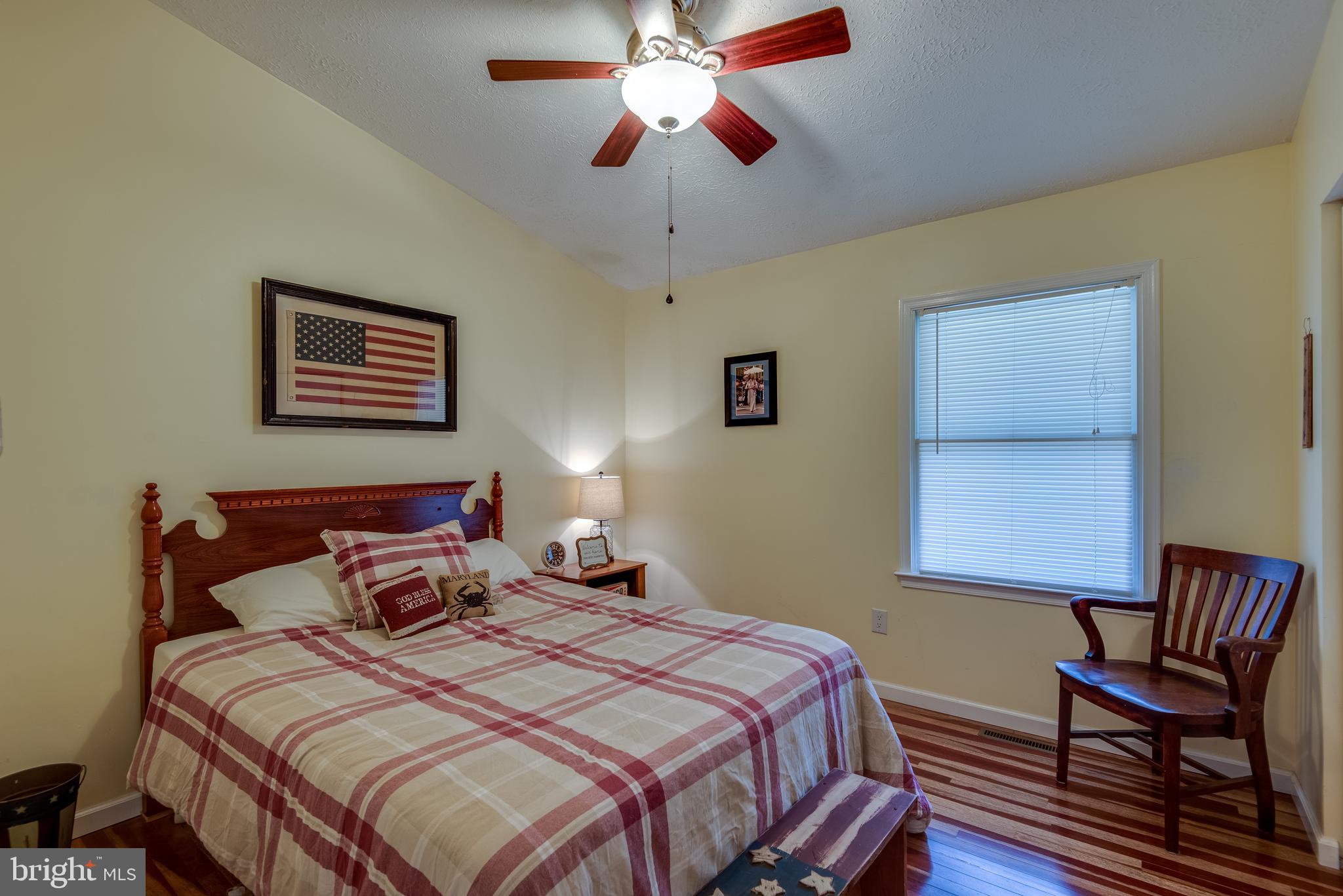 12430 Ridge Road Lusby, MD 20657 - Photo 28 of 36 a bedroom with a bed and a chair