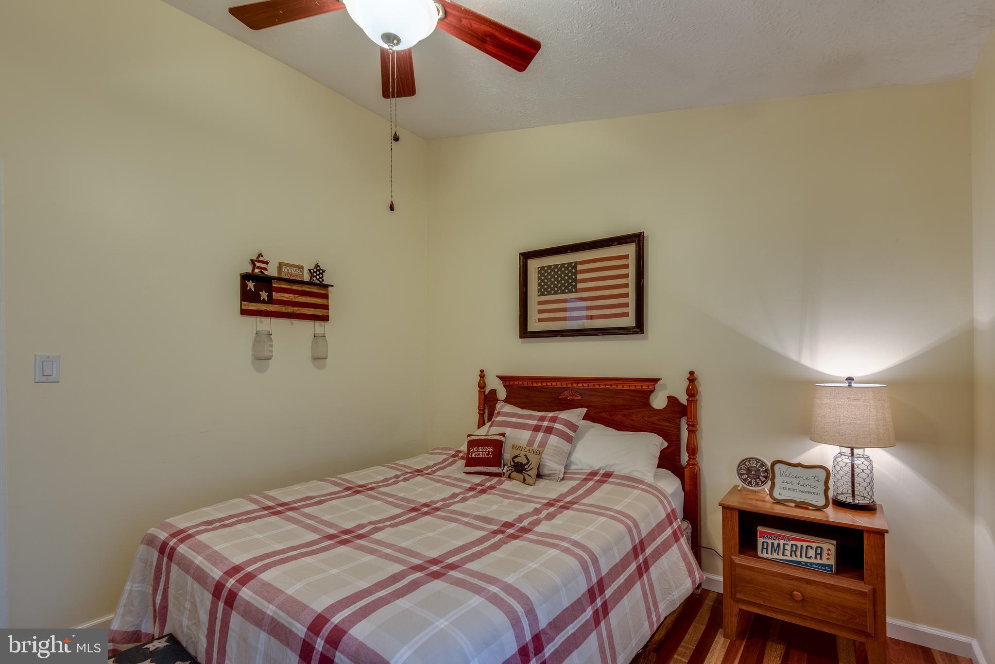 12430 Ridge Road Lusby, MD 20657 - Photo 29 of 36 a bedroom with a bed and a chandelier