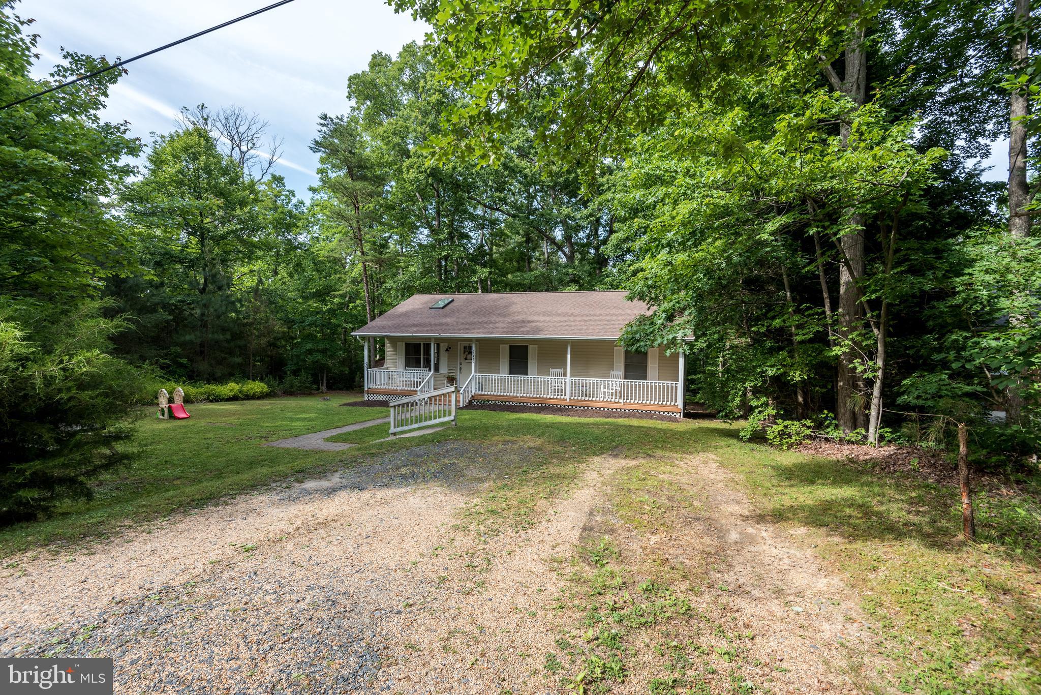 12430 Ridge Road Lusby, MD 20657 - Photo 33 of 36 a front view of a house with a yard