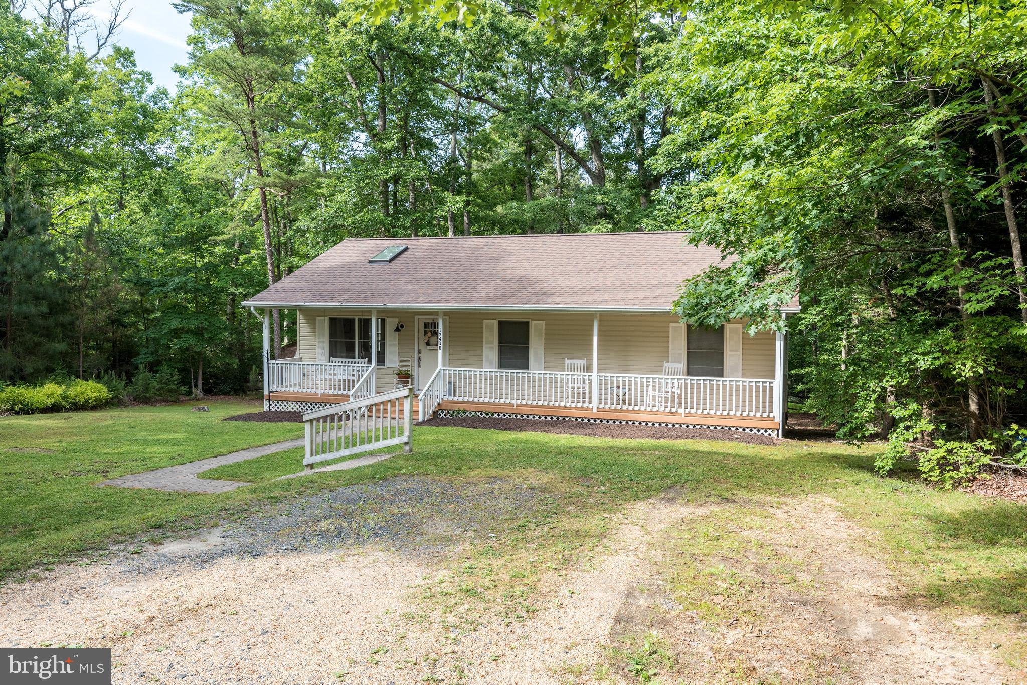 12430 Ridge Road Lusby, MD 20657 - Photo 34 of 36 a front view of a house with a garden and trees