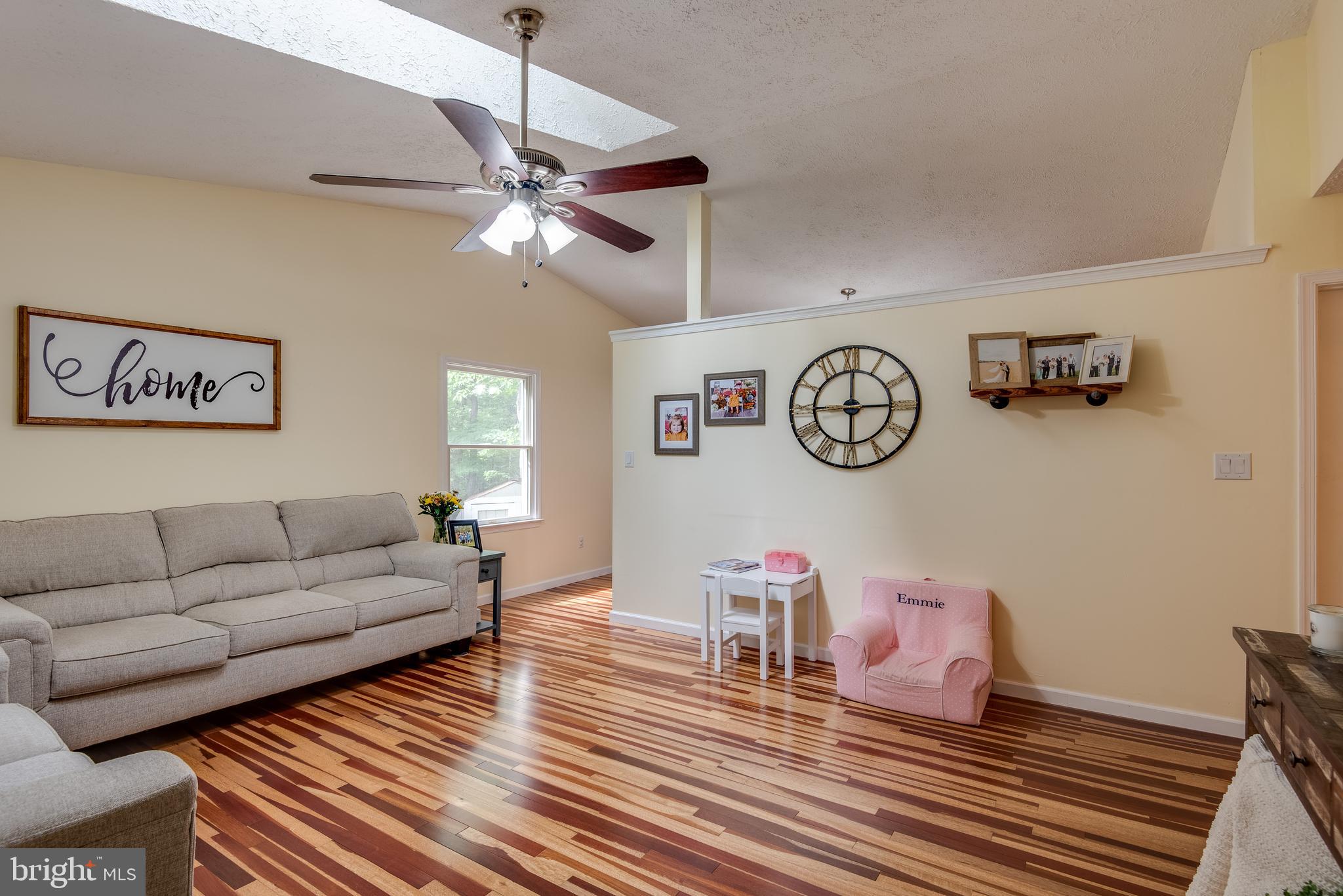 12430 Ridge Road Lusby, MD 20657 - Photo 6 of 36 a living room with furniture a clock on wall and a table