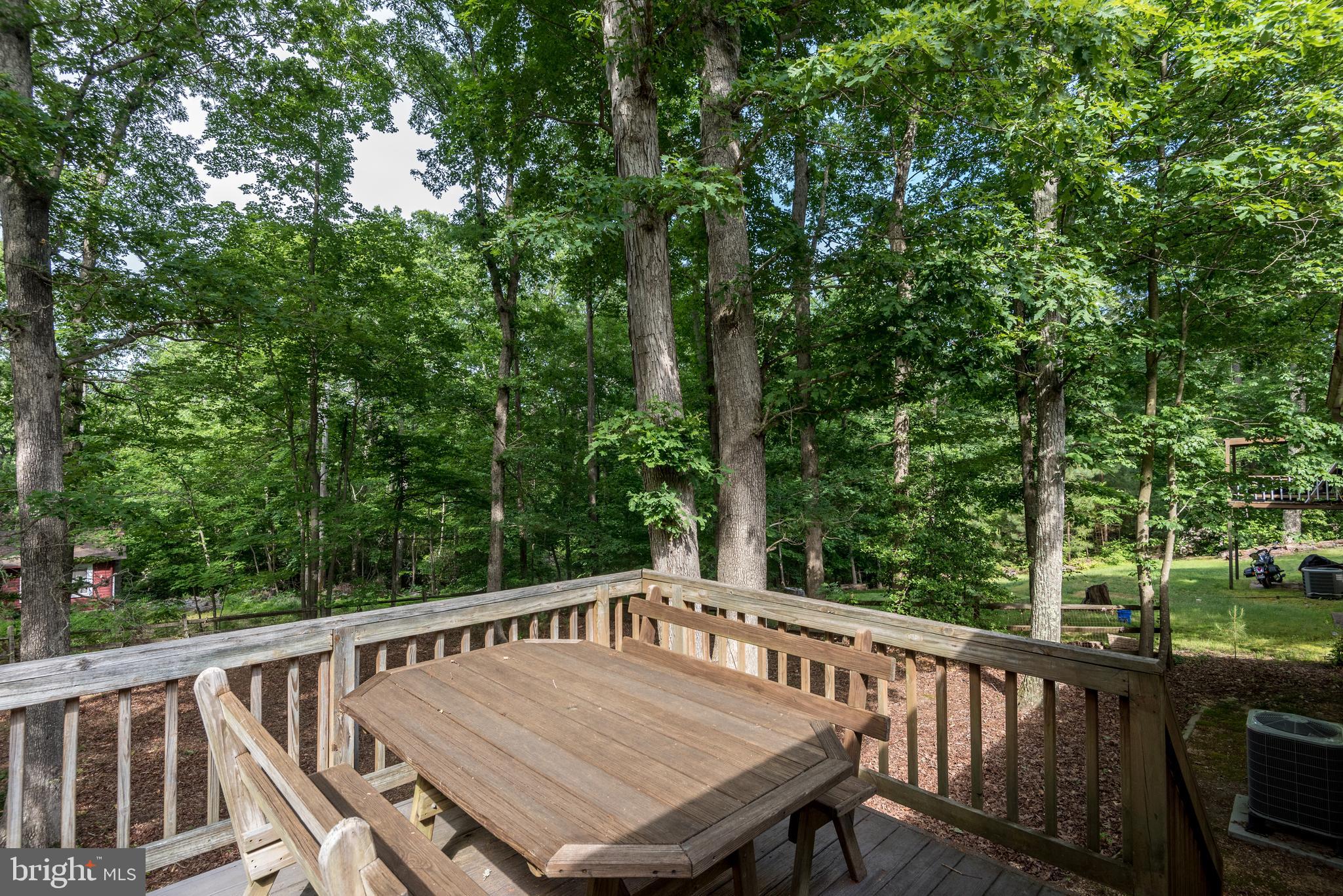 12430 Ridge Road Lusby, MD 20657 - Photo 7 of 36 a view of balcony with furniture and trees