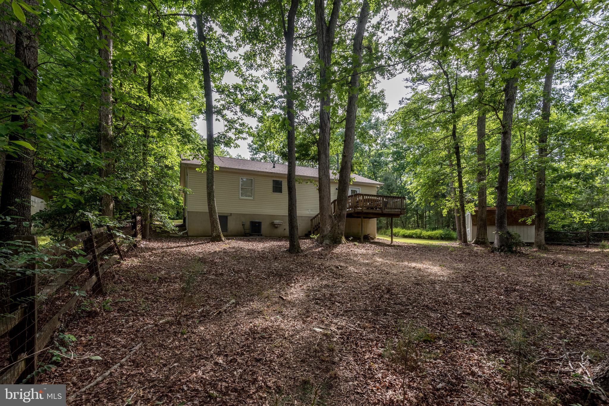 12430 Ridge Road Lusby, MD 20657 - Photo 9 of 36 a view of a house with backyard and trees