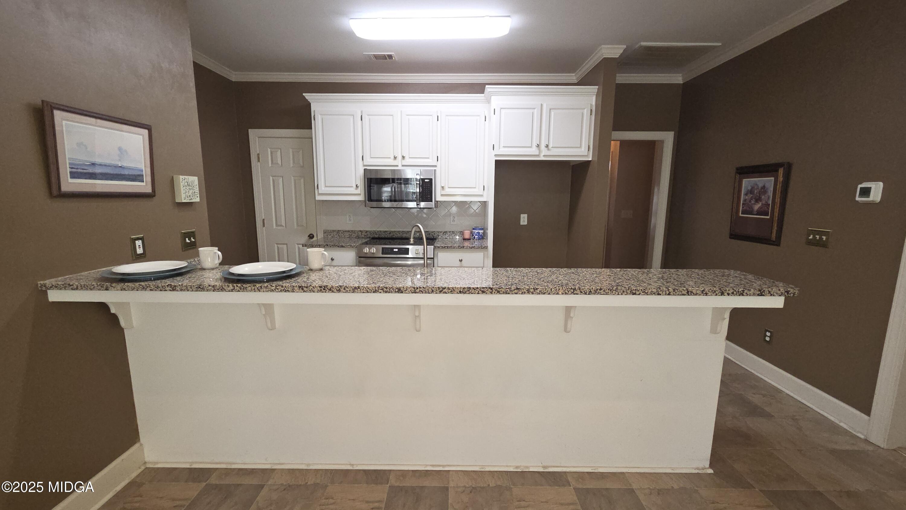 107 North Wellington Macon, GA 31210 - Photo 11 of 23 a bathroom with a granite countertop sink a toilet a large mirror and shower