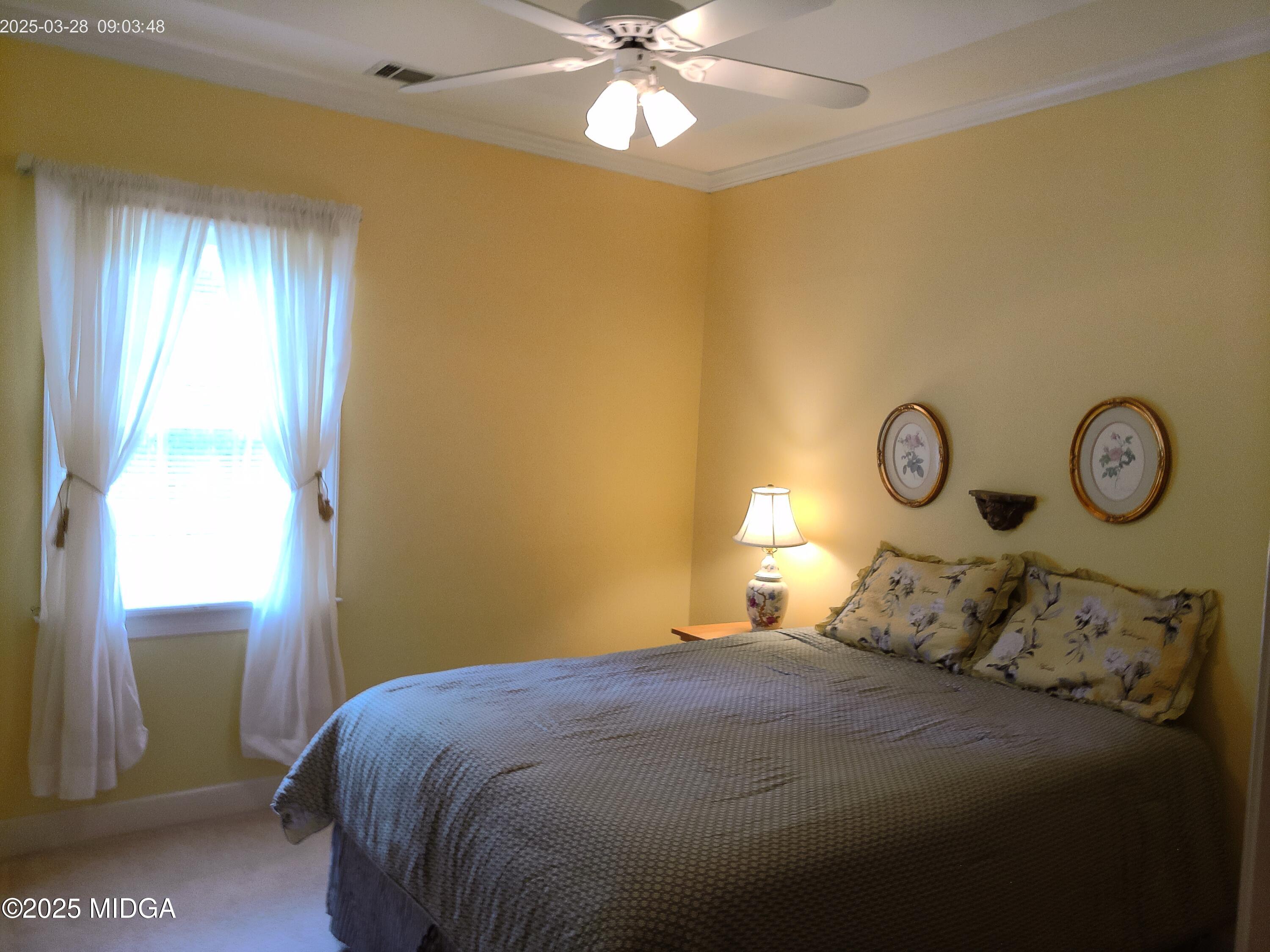 107 North Wellington Macon, GA 31210 - Photo 17 of 23 a bedroom with a bed and a chandelier