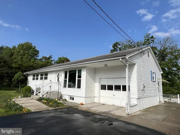 a view of a white house with yard