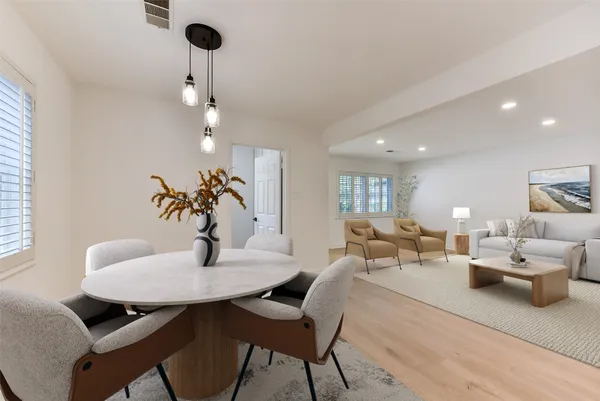 a living room with furniture potted plant and a chandelier