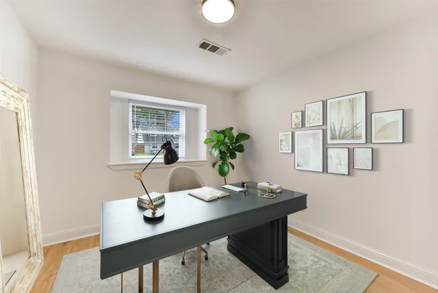 a view of a dining room with a table and chairs