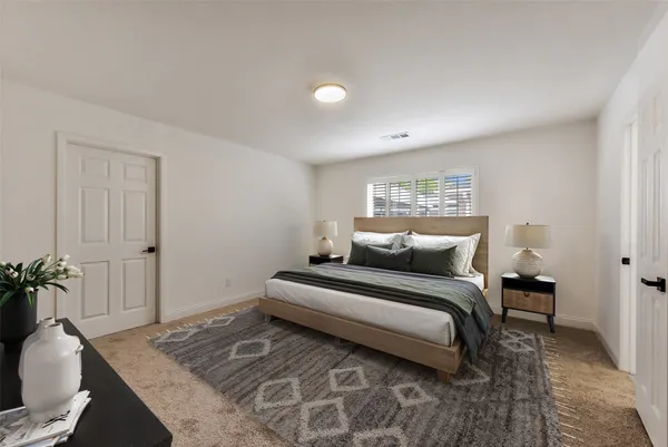 a bedroom with a bed and a couch