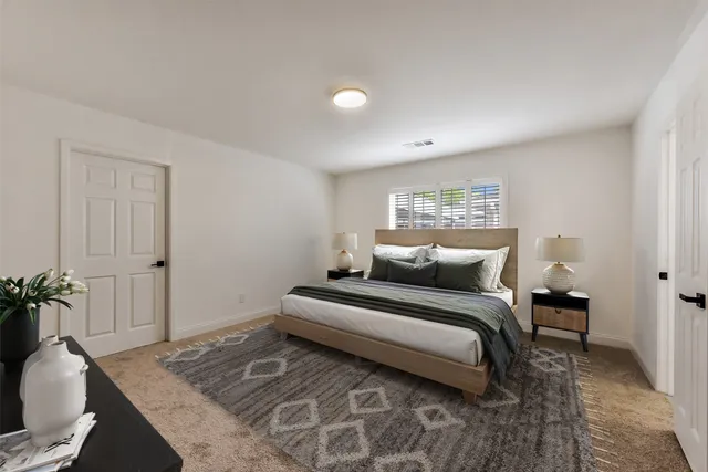 a bedroom with a bed and a couch