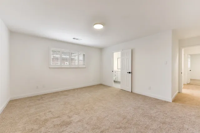 an empty room with a empty space and windows