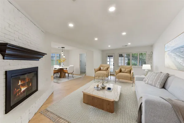 a living room with furniture fireplace and window