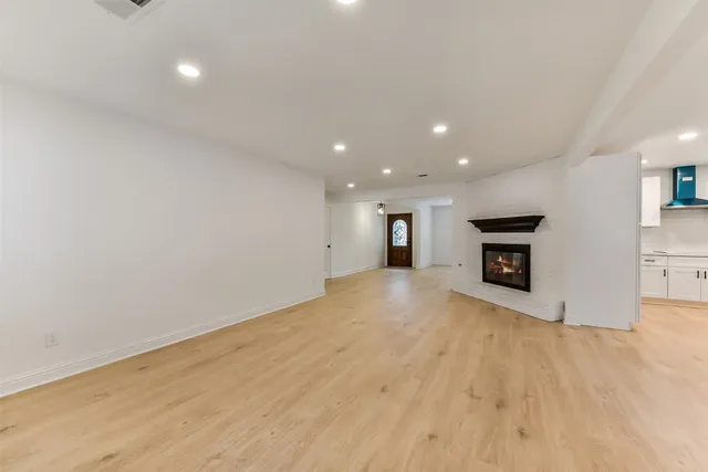 a view of an empty room with a fireplace