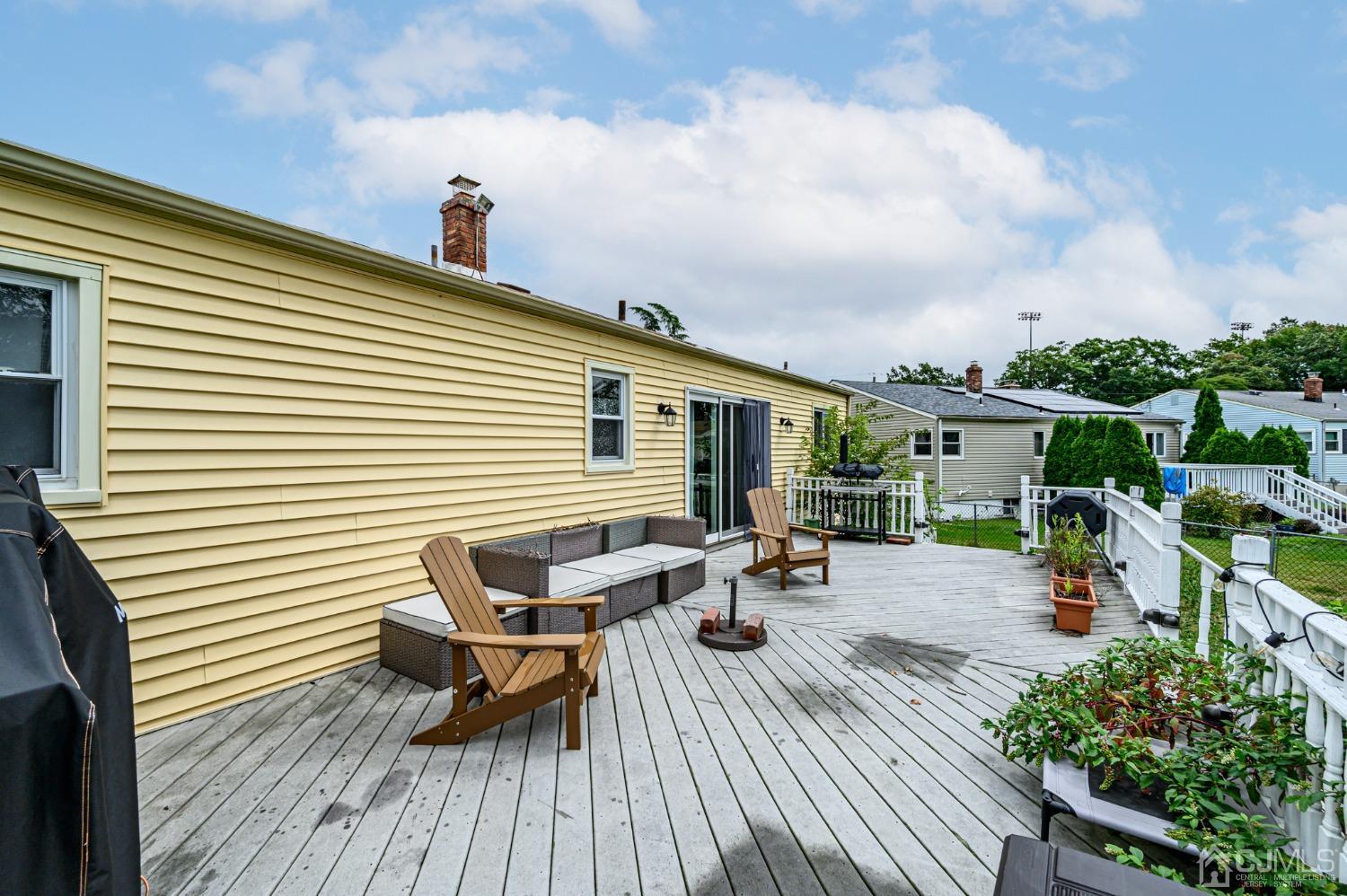 10 Ferris Road Edison, NJ 08817 - Photo 29 of 32 a view of a roof deck with table and chairs and wooden floor