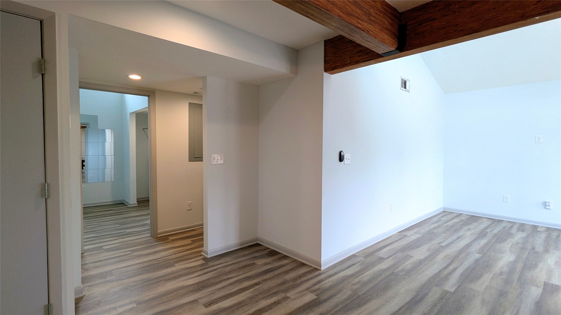4505 Teri Road, Unit A Austin, TX 78744 - Photo 9 of 23 Exposed wood beams add a rustic touch to this room with sloped ceilings.