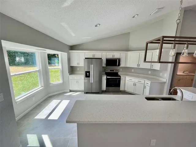 a spacious bathroom with a double vanity sink and a large mirror