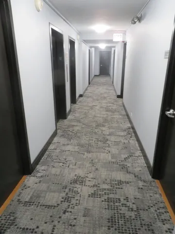 a view of a hallway with seating area