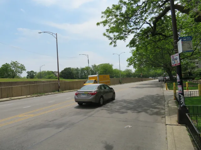 a front view of a residential houses with yard and green space