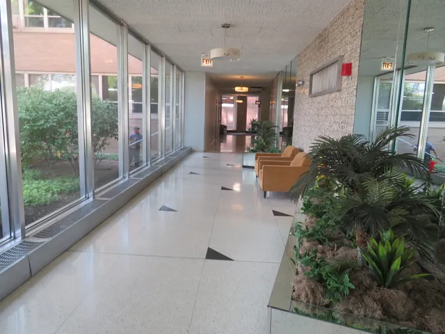 a living room with furniture and large windows