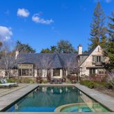 a aerial view of a house with swimming pool and sitting area