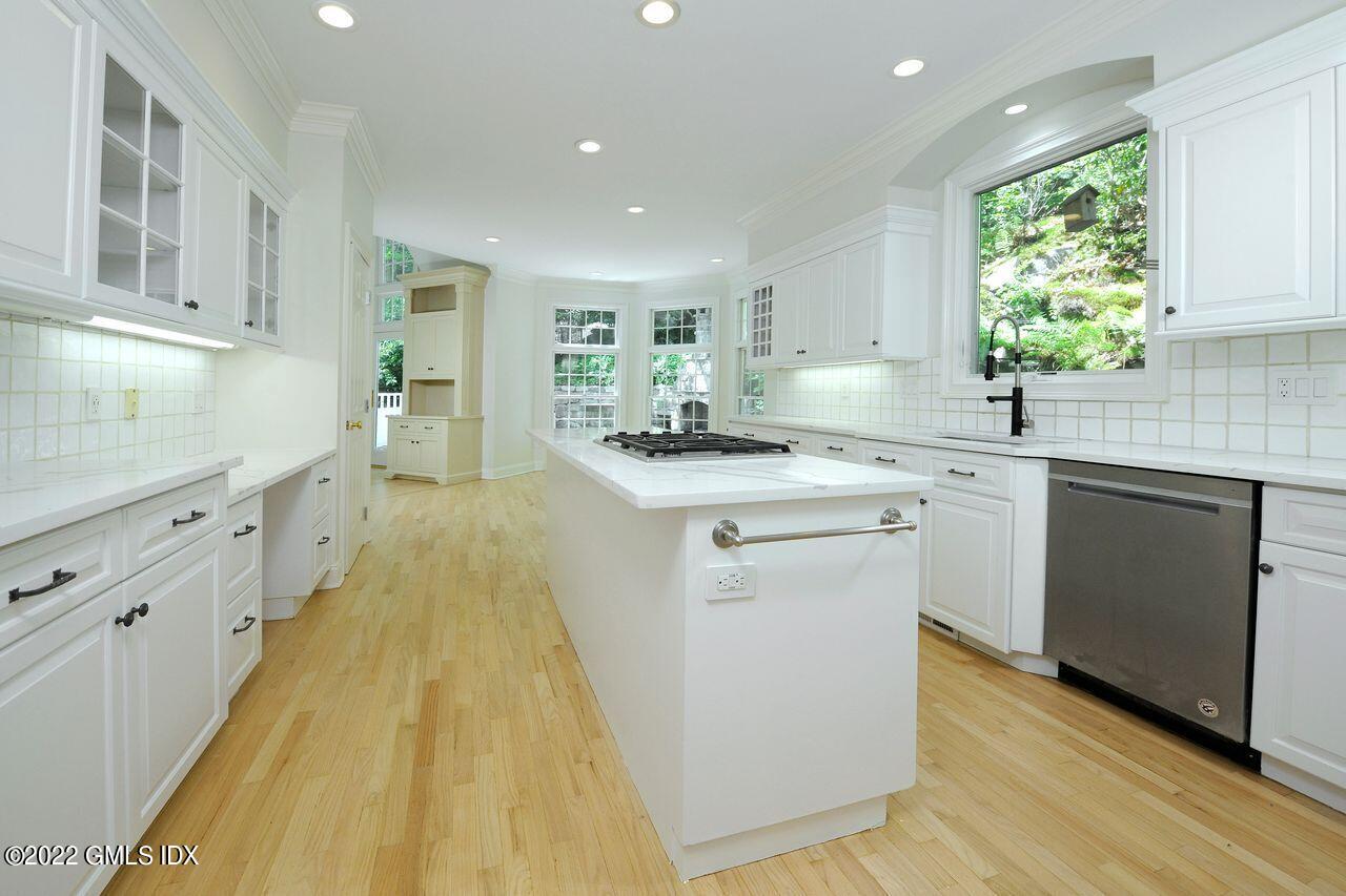 15 Horseshoe Road Cos Cob, CT 06807 - Photo 11 of 33 a kitchen with granite countertop a sink stove and cabinets