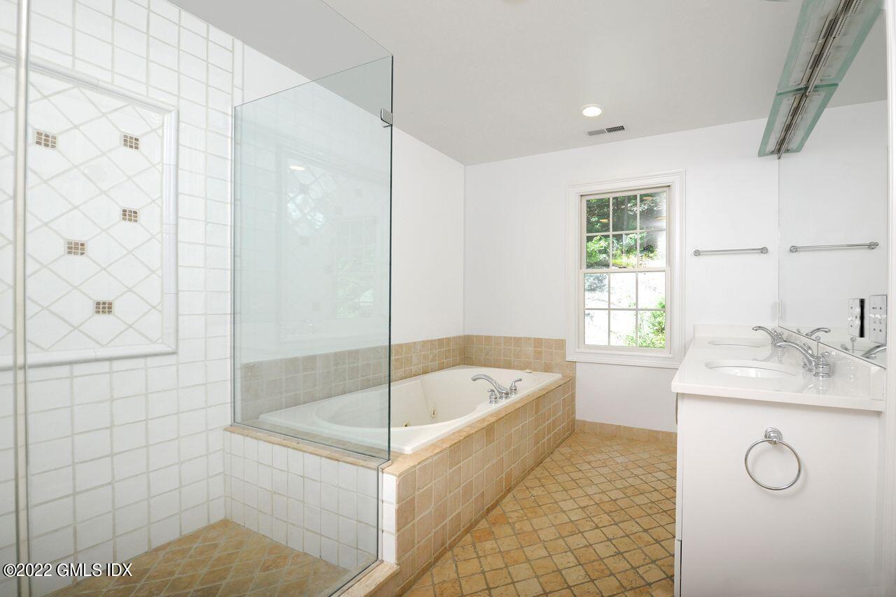 15 Horseshoe Road Cos Cob, CT 06807 - Photo 15 of 33 a bathroom with a tub sink and mirror