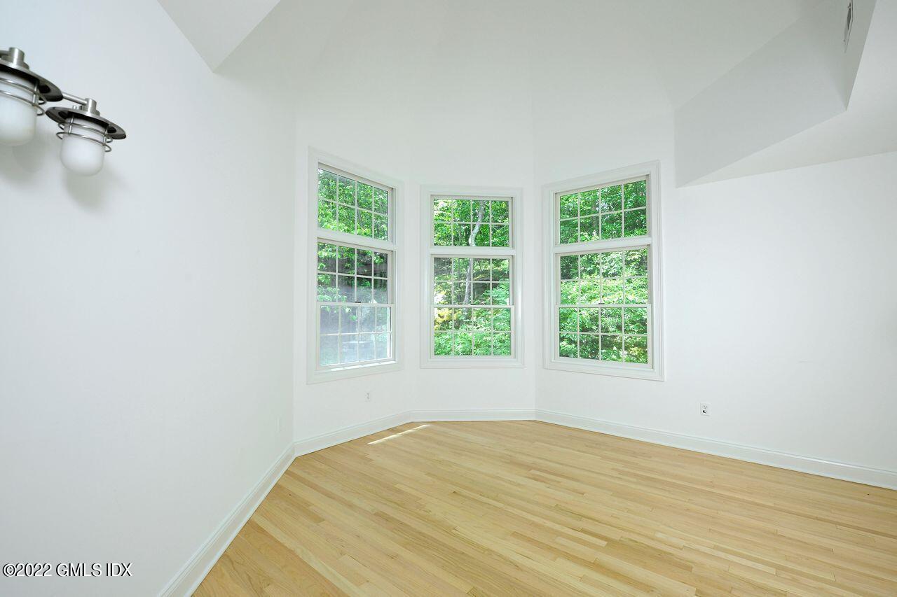 15 Horseshoe Road Cos Cob, CT 06807 - Photo 17 of 33 a view of empty room with wooden floor and fan