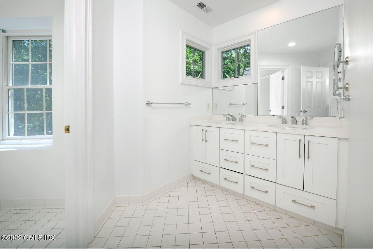 15 Horseshoe Road Cos Cob, CT 06807 - Photo 18 of 33 a bathroom with a sink a vanity and a mirror