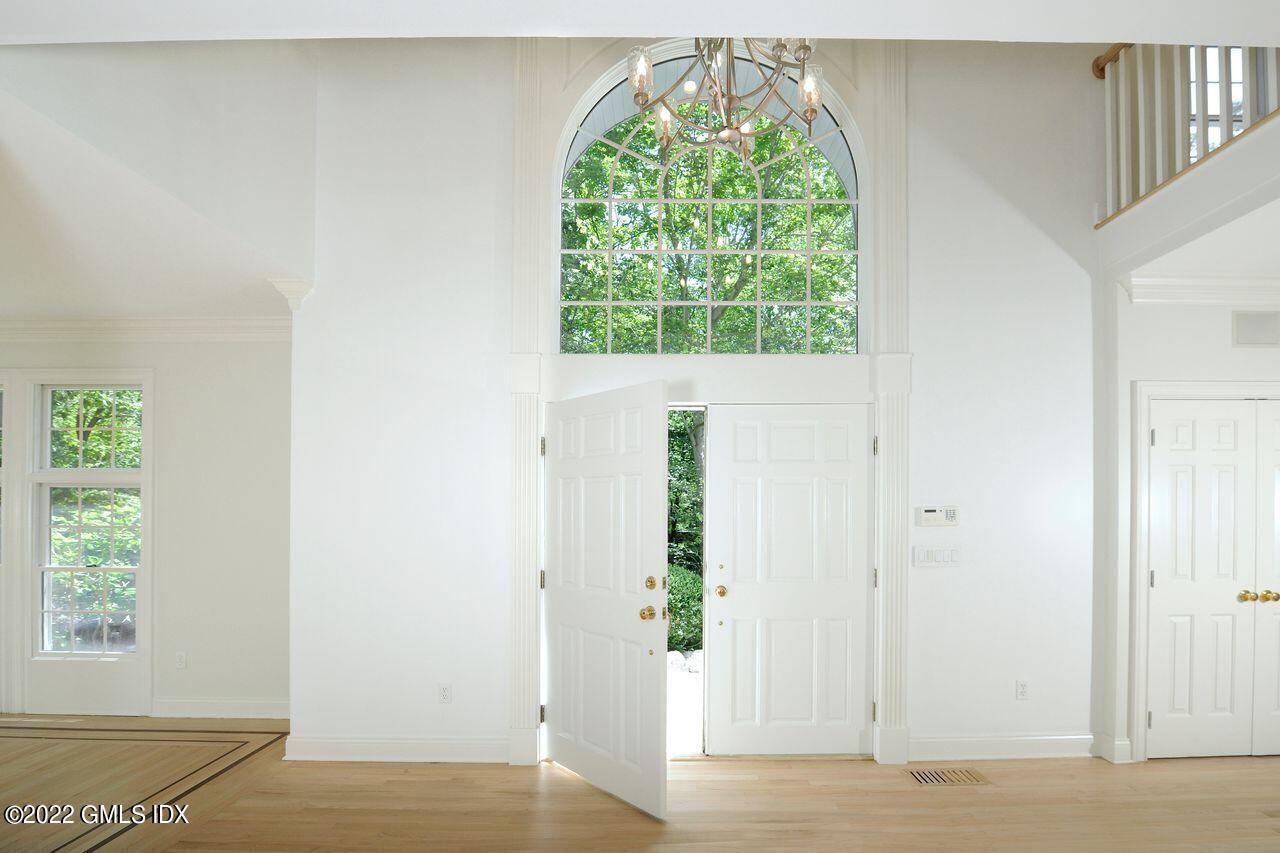 15 Horseshoe Road Cos Cob, CT 06807 - Photo 4 of 33 an empty room with wooden floor and a window