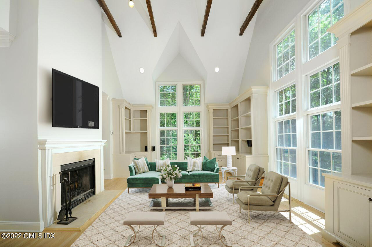 15 Horseshoe Road Cos Cob, CT 06807 - Photo 5 of 33 a living room with furniture a fireplace and a flat screen tv