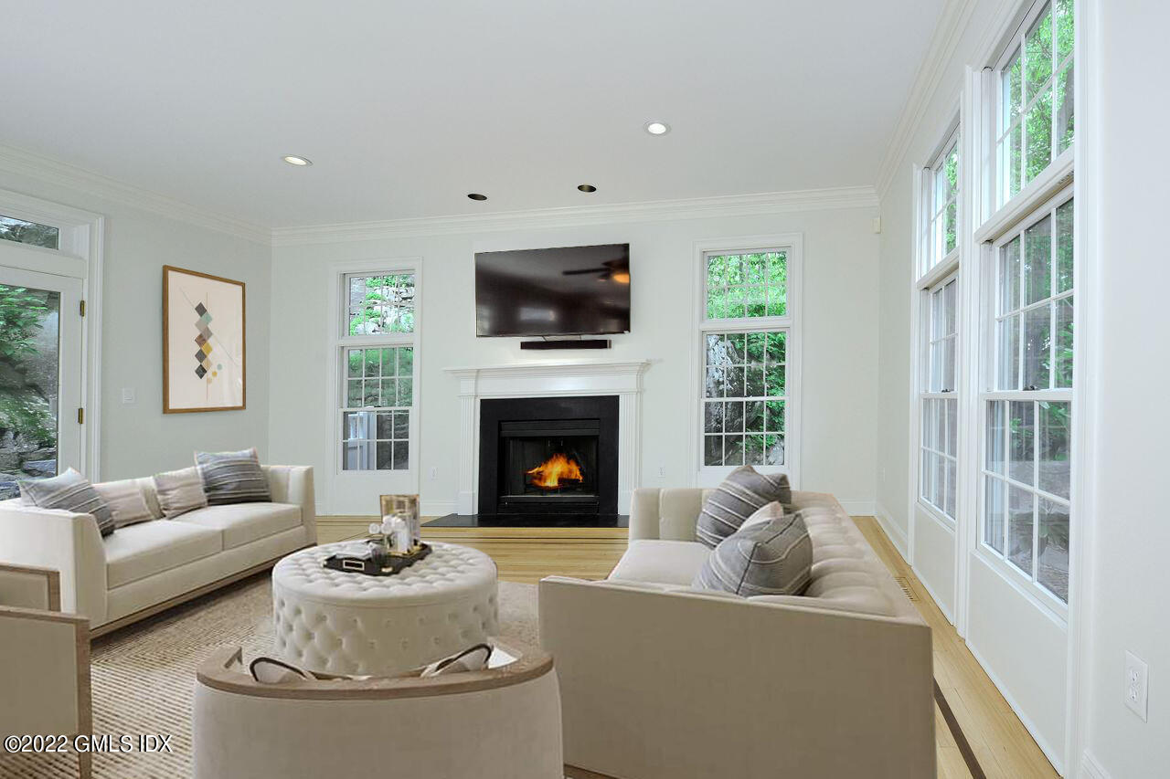 15 Horseshoe Road Cos Cob, CT 06807 - Photo 7 of 33 a living room with furniture a fireplace and a flat screen tv