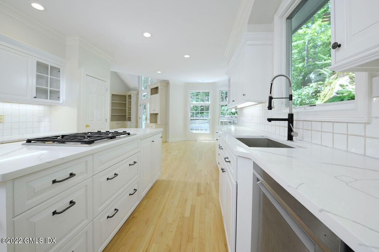 15 Horseshoe Road Cos Cob, CT 06807 - Photo 10 of 33 a spacious bathroom with a double vanity sink and a large mirror