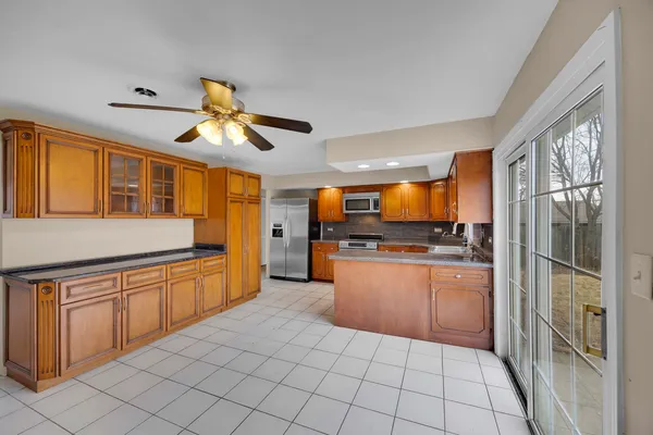 a kitchen with stainless steel appliances granite countertop a refrigerator and a sink