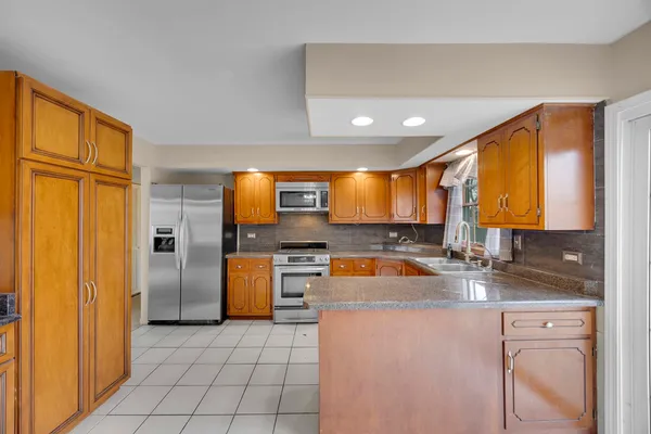 a kitchen with a refrigerator a sink and a cabinets