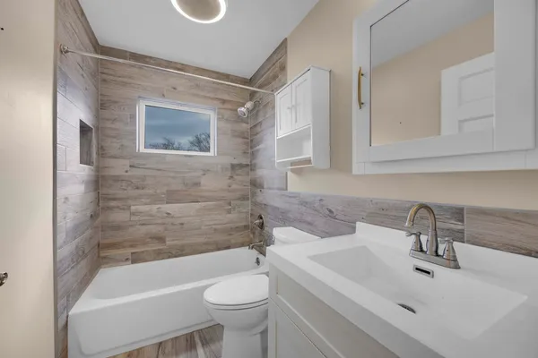 a bathroom with a sink a toilet and bathtub