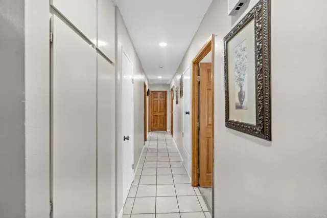 a bedroom with a bed chandelier and a window