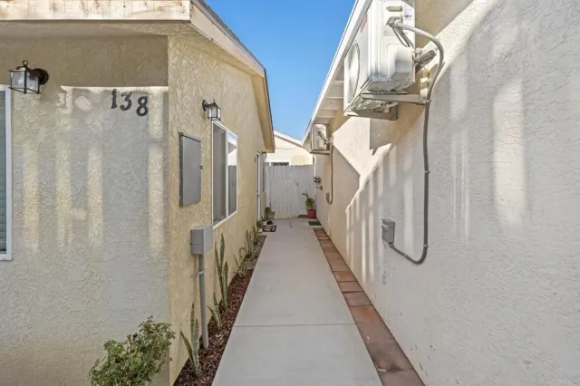 a view of a house with a wooden fence