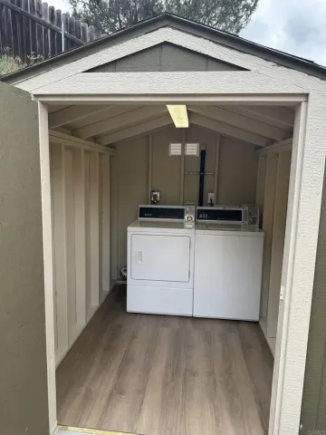 a view of a house with a car parked beside it
