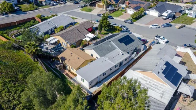 an aerial view of a house with garden space and street view