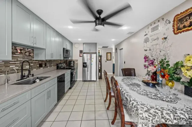 a kitchen with granite countertop a sink appliances cabinets and counter space